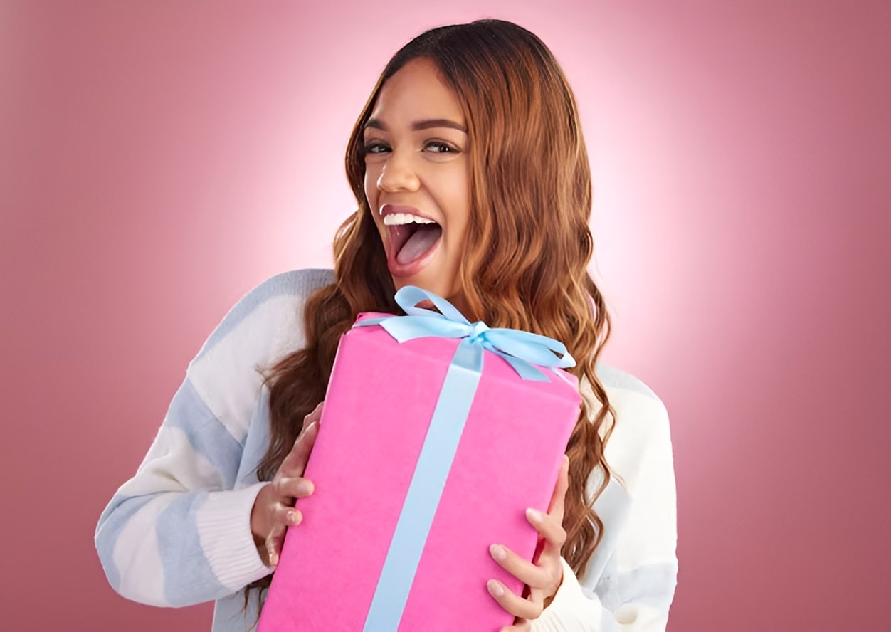 gift portrait happy woman studio with present birthday celebration prize pink background smile box face girl with package giveaway party gesture while posing iolated